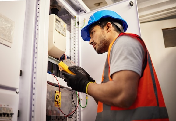 Local electrician connecting dual wire socket contacts in a Bromley property
