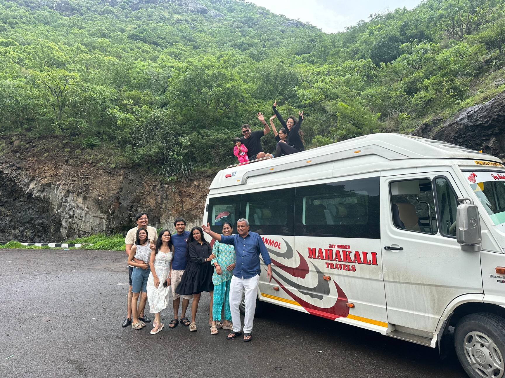 Happy group boarding Tempo Traveller for outstation trip