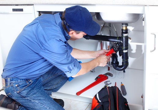 Plumber inspecting leaking pipe in Newhall, CA